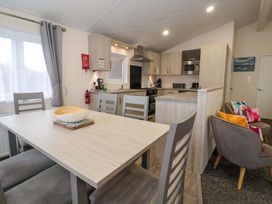 A kitchen with dining table and chairs at Brighter Daze in Carnaby near Bridlington