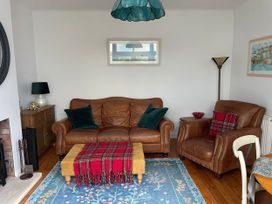 A living room with a sofa and armchair at The Nook in Weymouth