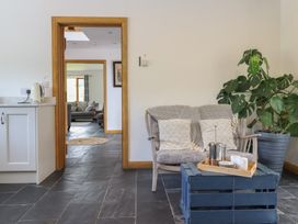 A living room with a coffee table and armchair at Cwmwr in Penybontfawr