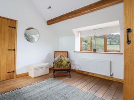 A snug with a chair and window at Cwmwr in Penybontfawr