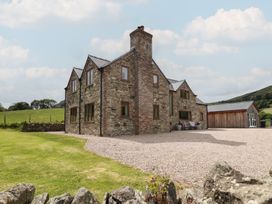 A house with windows and a chimney in a field at Cwmwr Penybontfawr