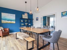 A dining room with a table and chairs at Beach Haven in Perranporth