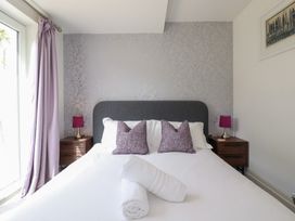 A bedroom with a bed and bedside tables at Beach Haven in Perranporth