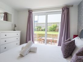 A bedroom with a bed and dresser at Beach Haven in Perranporth