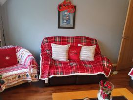 A living room with sofas and decorative cushion at Normandy in Nefyn