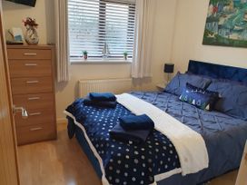 A bedroom with a bed and dresser at Normandy in Nefyn