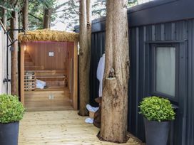A sauna with wooden steps and potted plants at The Nest in Prestatyn