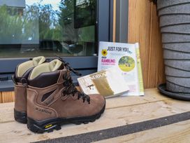 Hiking boots next to a magazine on a table at The Nest in Prestatyn
