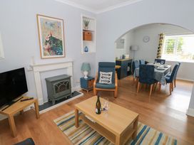 A living room with a television and coffee table at Longmoor in Tenby