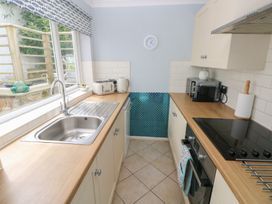 A kitchen with a sink and various appliances at Longmoor in Tenby