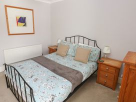 A bedroom with a bed and bedside tables at Longmoor in Tenby