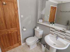 A bathroom with a toilet and sink at Longmoor in Tenby