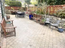 A garden with benches and a table at The Grain Store in Weymouth
