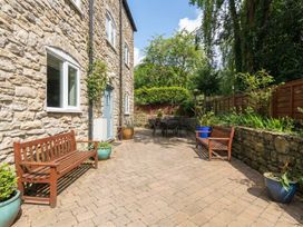 An outdoor area with stone walls and seating at The Grain Store in Weymouth