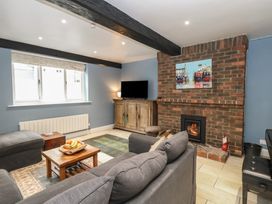 A living room with a sofa and television at The Grain Store in Weymouth
