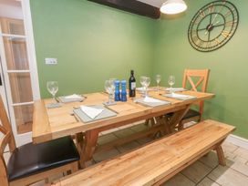 A dining room with a wooden table and chairs at The Grain Store in Weymouth