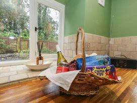 A kitchen with a basket of food items on the countertop at The Grain Store in Weymouth