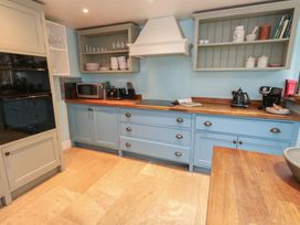 A kitchen with cabinets and appliances at The Grain Store in Weymouth