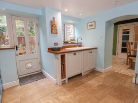A kitchen with a sink and wooden countertop at The Grain Store in Weymouth