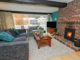 A living room with a television and a fireplace at The Grain Store in Weymouth
