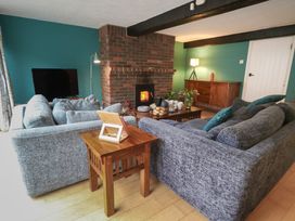 A living room with a sofa and a fireplace at The Grain Store in Weymouth