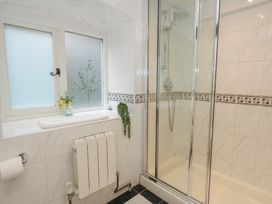 A bathroom with a shower and window at The Grain Store in Weymouth