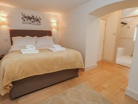 A bedroom with a bed and towels at The Grain Store in Weymouth
