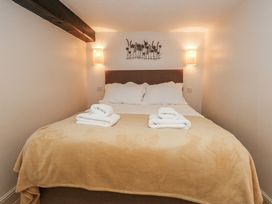A bedroom with a bed and towels on it at The Grain Store in Weymouth