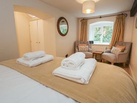 A bedroom with a bed and armchairs at The Grain Store in Weymouth
