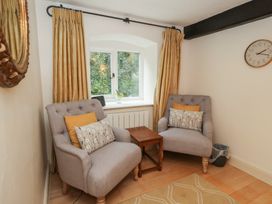 A snug with two armchairs and a coffee table at The Grain Store in Weymouth