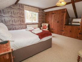 A bedroom with a bed and armchair at The Grain Store in Weymouth