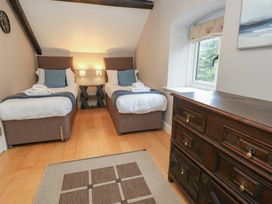 A bedroom with two beds and a dresser at The Grain Store in Weymouth
