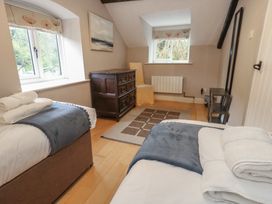 A bedroom with two beds and a dresser at The Grain Store in Weymouth