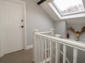 A landing with a staircase and a skylight at The Grain Store in Weymouth