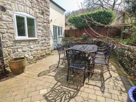 An outdoor patio with a table and chairs at The Grain Store in Weymouth