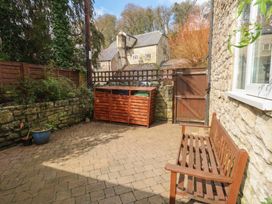 A garden with a bench and storage unit at The Grain Store in Weymouth