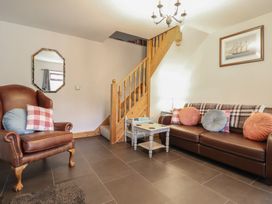 A living room with a sofa and armchair at Bridgeway House in Blaenau Ffestiniog