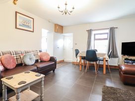 A living room with a sofa and dining table at Bridgeway House in Blaenau Ffestiniog