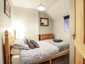 A bedroom with a bed and dresser at Bridgeway House in Blaenau Ffestiniog