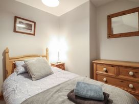 A bedroom with a bed and a dresser at Bridgeway House in Blaenau Ffestiniog
