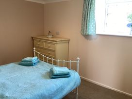A bedroom with a bed and a dressing table at Ty Croes in St. George near Bodelwyddan