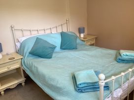 A bedroom with a bed and bedside tables at Ty Croes in St. George near Bodelwyddan
