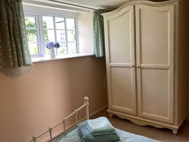 A bedroom with a wardrobe and bed at Ty Croes near St. George near Bodelwyddan