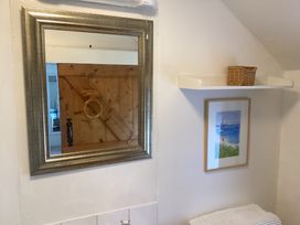 A bathroom with a mirror and shelf at Ty Croes in St. George near Bodelwyddan
