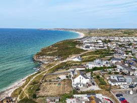 A coastal view with ocean and buildings at The Sandbox in Hayle