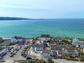 A view of buildings and cars near the sea at The Sandbox in Hayle