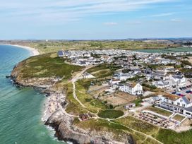 An aerial view of a coastal area with houses and beach at The Sandbox in Hayle