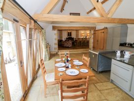 A kitchen with a dining table and chairs at Rookery Hall near Middle Hill