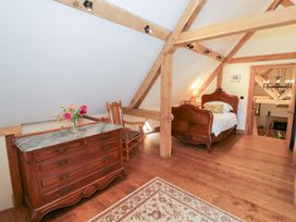 A bedroom with a bed and dresser at Rookery Hall near Middle Hill