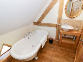 A bathroom with a bathtub and sink at Rookery Hall in Middle Hill near Broadway